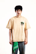 Person wearing a beige t-shirt with a graphic design on a white background