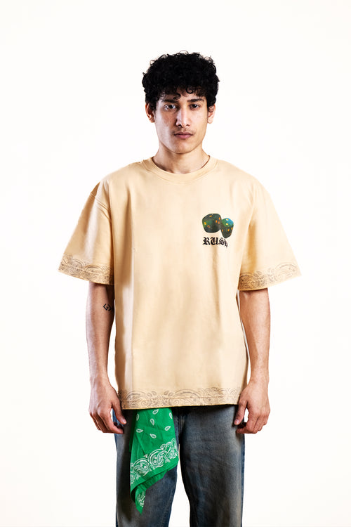 Person wearing a beige t-shirt with a graphic design on a white background