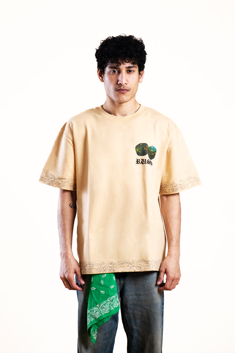 Person wearing a beige t-shirt with a graphic design on a white background
