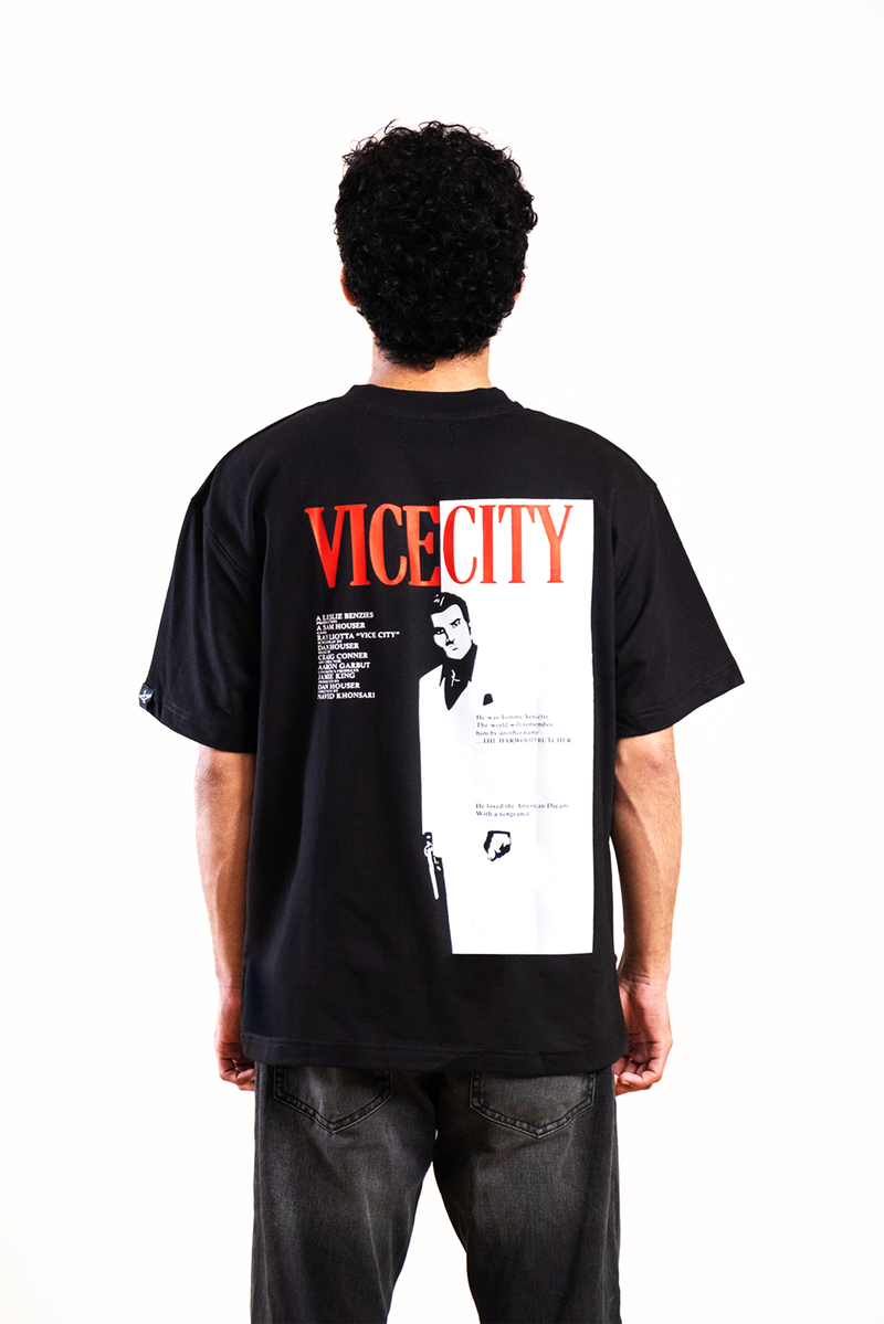 Person wearing a black t-shirt with 'Vice City' graphic design on the back.