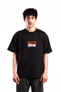 Person wearing a black t-shirt with a logo on a white background
